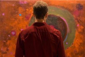 man seeing a piece of art